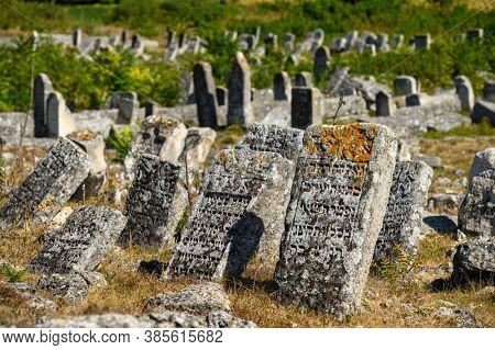 Vadul Rascov, Soldanesti, Moldova, September 2020: Old ruined tombstones at the ancient Jewish cemetery, now abandoned. Jewish communuty was massacred by nazis during WW2.