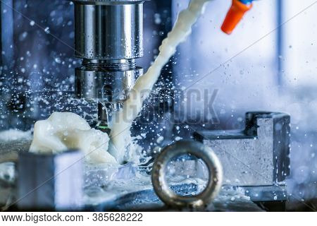 Close-up View Of Vertical Cnc Steel Milling Process With External Water Coolant Streams And Splashes