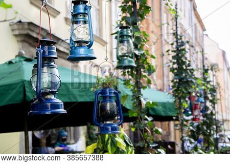 Close Up Picture Of Kerosene Lighting, As Decoration On The Street In Blue Green Shades. Cafe Decor 