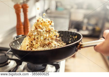 Onions And Bacon Tossed In A Pan Inside The Kitchen. Khichri Tossed In A Wok Pan
