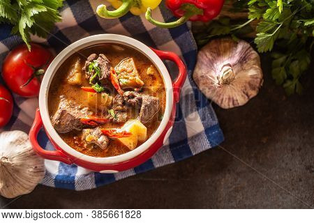 Top Views Of Bowl Of Goulash Soup With Meat, Potatoes And Chillies