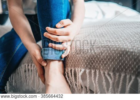 Young Girl Holds On To A Sore Leg. Close-up