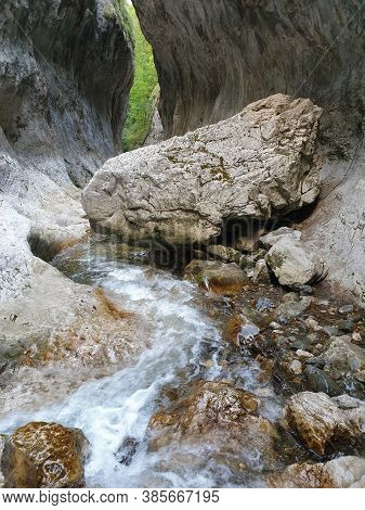 Cheile Rametului Gorges Wild Natural Park River Area. Waterfall On Small River In Dense Forest In Al