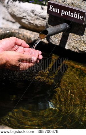 Correze, France - July 14 2020 : Man Drinking Water At The Fountain