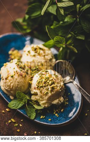 Scoops Of Turkish Dessert Semolina Helva With Pistachio And Mint