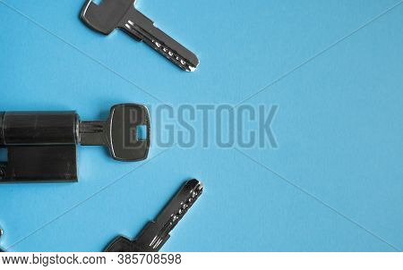 A Door Lock Cylinder Core With Keys On The Blue Background. The Cylinder Of The Lock With Keys. Inst