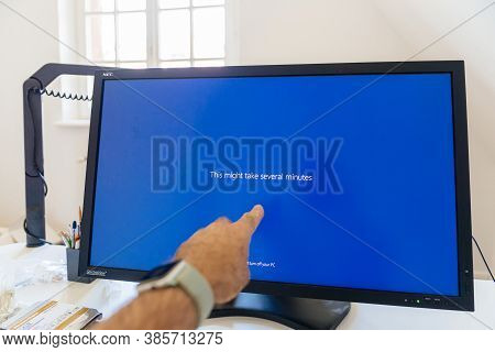 Paris, France - Sep 7, 2020: Pov Male Hand Pointing To Large Nec Spectraview Reference Monitor Showc