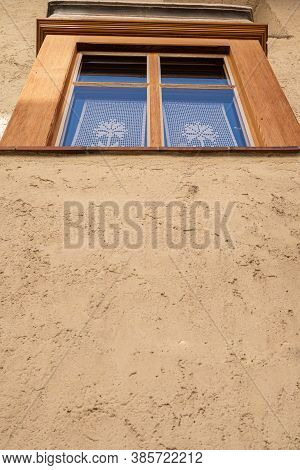Mustair, Switzerland - September 8, 2020: A Window With Lace On The Wall Of An Old House In Mustair