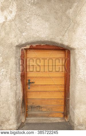 Mustair, Switzerland - September 8, 2020: The Low Wooden Door Of An Old House In Mustair
