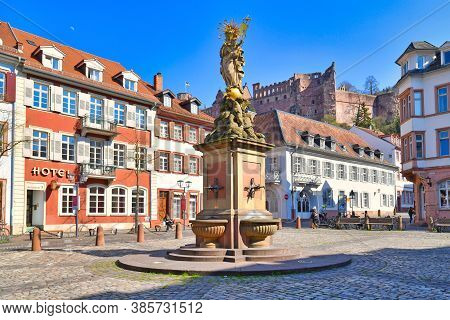 Heidelberg, Germany - April 2020: Square Called 'kornmarkt' In Old Historical City Center, Fountain 