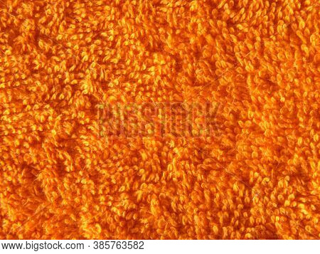 Orange Rug With Soft Fur That Looks Luxurious To The Touch. Wallpaper With Copy Space. Background Or