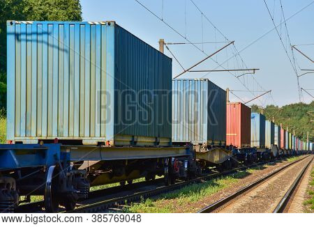 Cargo Containers Transportation On Freight Train By Railway. Intermodal Container On Train Car. Rail