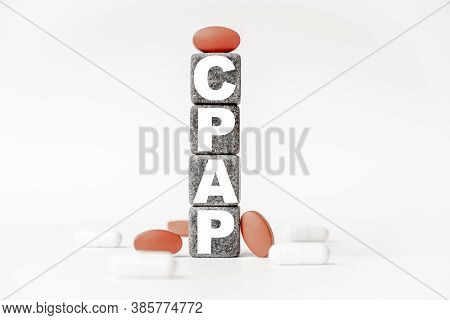 A Group Of White And Red Pills And Cubes With The Word Cpap Continuous Positive Airway Pressure On T