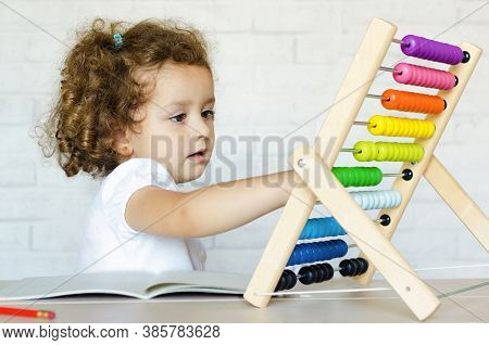 Preschooler Child Learning To Count. Girl Playing With Mathematical Abacus. Kid And Math. Developmen