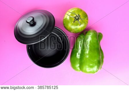 Black Pot, Green Pepper And Green Tomato