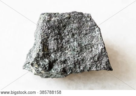 Closeup Of Sample Of Natural Mineral From Geological Collection - Rough Magnetite Ore On White Marbl
