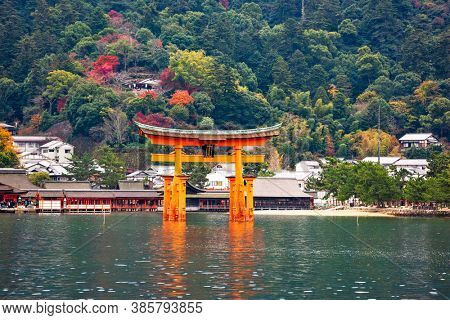 The Itsukushima Shrine Otorii Gate from the water at Miyajima Island, Hiroshima, Japan. (sign reads: Itsukushima Shrine)
