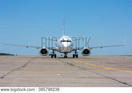 The Passenger Airplane Moves On The Taxiway In The Hot Summer Day