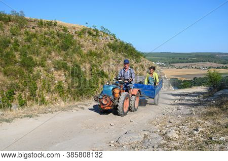 Socola village, Soldanesti, Moldova, September 2020: Mini tractor at mountain road iwith passenger. This mode of working transport bacomes popular at bad roads in this region.