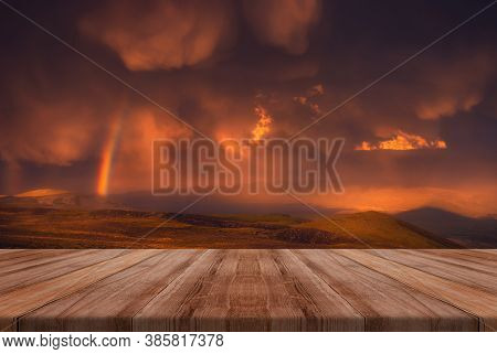 The Sky With Beauriful Clouds And A Rainbow After The Rain With Empty Wooden Table. Natural Template