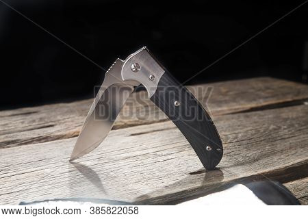 Folding Pocket Knife With One Edge On Wooden Background