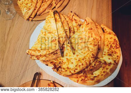 Georgian Cuisine Slised Megrelian Khachapuri Bread On The Wooden Table.