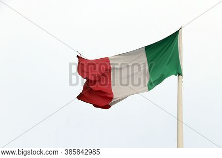 Tri Color Of Italian Flag, Green White And Red Color With On Sky Background. Blown Away By Wind.