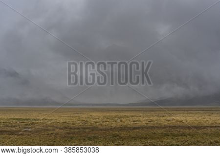 Rain At The Pamir Highway In Tajikistan Near Alichur And Murghab With Dark Clouds.