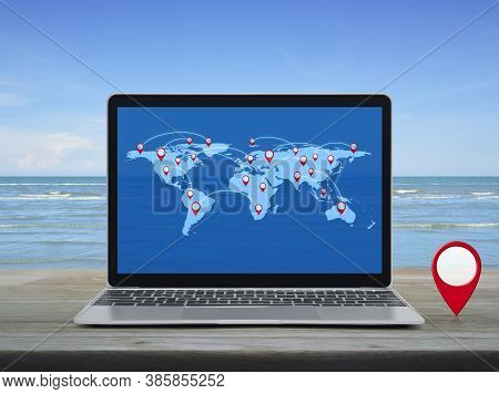 Map Pin Location Button With Connection Line And World Map On Modern Laptop Computer On Wooden Table