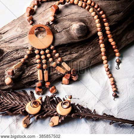 Handmade Wooden Necklace And Earring On The White And Black Background