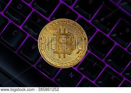 Bitcoin On Compuer Keyboard In Background, Symbol Of Electronic Virtual Money And Mining Cryptocurre