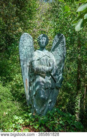 Lluc, Balearic Islands/spain; September 2020: Bronze Sculpture Of An Angel Surrounded By Vine Plants