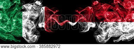 Italy Vs Monaco, Monacan Smoky Mystic Flags Placed Side By Side. Thick Colored Silky Abstract Smoke 