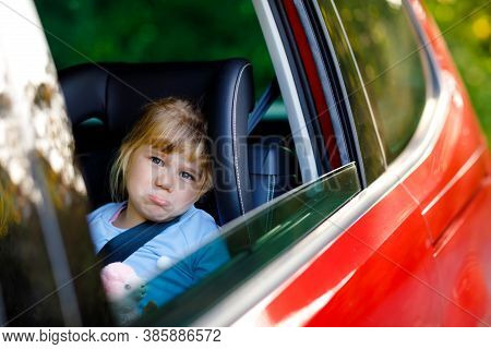 Sad Upset Little Kid Girl Sitting In Car In Traffic Jam During Going For Summer Vacation With His Pa