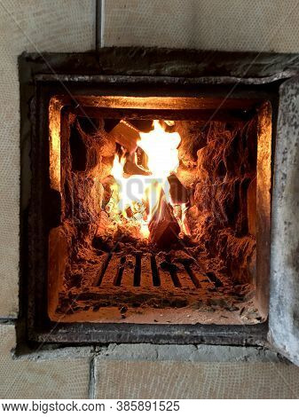 Beautiful Red Fire From Slice Wood, Dark Grey Black Coals Inside Metal Brazier. Wood Burning In The 
