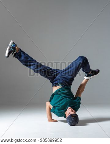 Sporty Guy Breakdancer Dancing On The Floor Isolated On Gray Background. Breakdance Poster