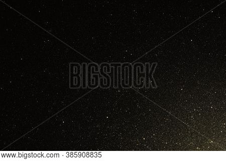 Black Texture With Micro-relief And Glitter. Black Glitter Texture Illuminated From Bottom Right To 