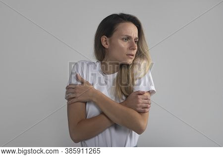 Frustrated Shocked Woman Shivers Indoor, Keeps Hands Crossed Over Chest, Notices Something Terrible,