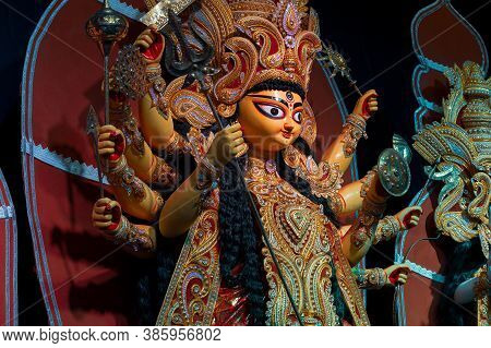 Decorated Durga Puja Pandal With Durga Idol, Durga Puja Festival At Night. Shot Under Colored Light 