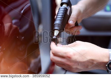 Man Fixing Car Dent By Himself. Bodyshop