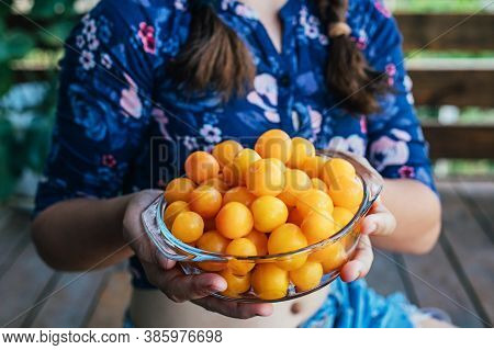 Young Girl Holding Yellow Fruits In Her Hands, Healthy Breakfast, Snack. Selective Focus