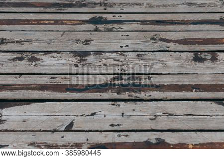 Close-up View Of Gray And Brown Wooden Fence Panels. Wood Pattern Background Texture. Old Gray Woode