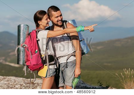 Two backpackers in mountains.