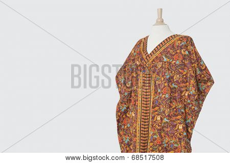 Traditional African dashiki on tailor's dummy over gray background