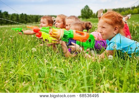 Five kids play with water guns