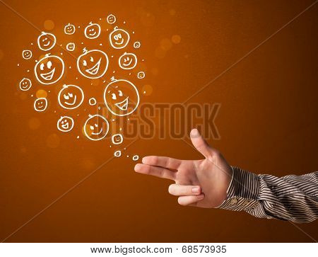Group of happy hand drawed smiley faces coming out of gun shaped hands