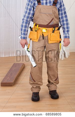Carpenter With Spirit Level And Gloves