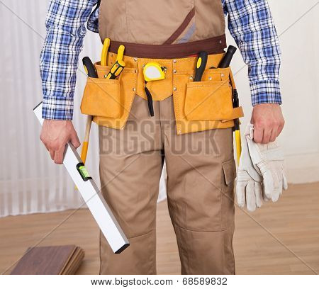 Carpenter With Spirit Level And Gloves
