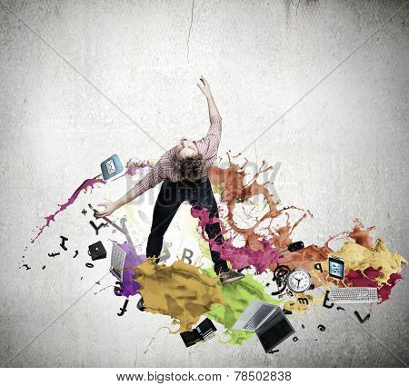 Young guy in casual evading from colorful splashes