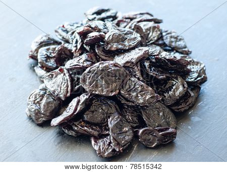 Dried Prunes On Black Background